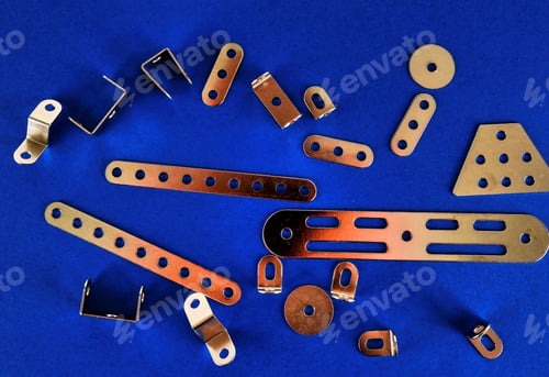 Preview: High angle shot of metal details of a mechanism on a blue background