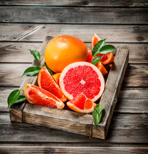 Preview: Ripe grapefruit on a wooden tray.