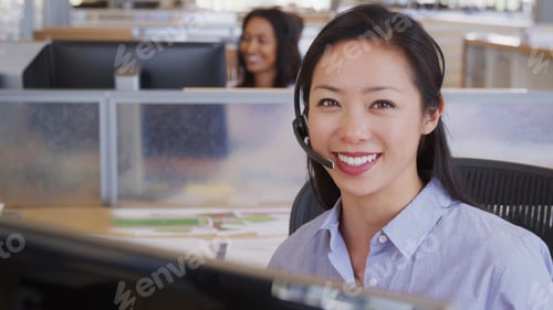 Preview: Portrait Of Female Customer Support Or Telesales Team Agent In Office Wearing Headsets