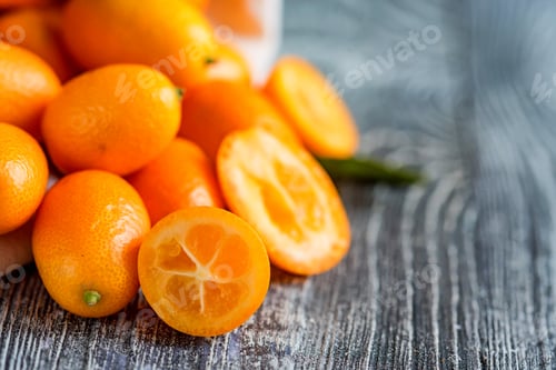 Preview: Kumquat or cumquat on wooden table