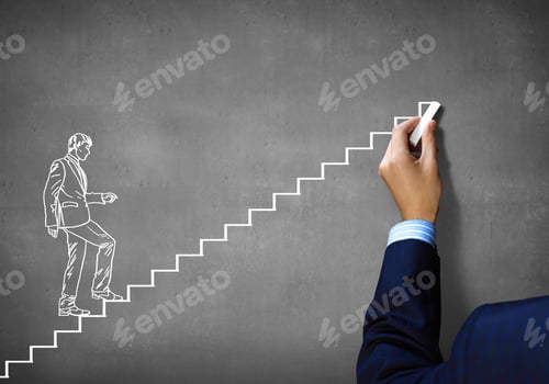 Preview: Close Up Of Human Hand Drawing Career Ladder With Chalk