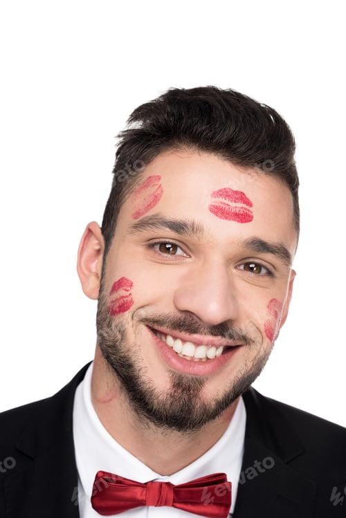Preview: smiling handsome man with lips traces on face looking at camera isolated on white
