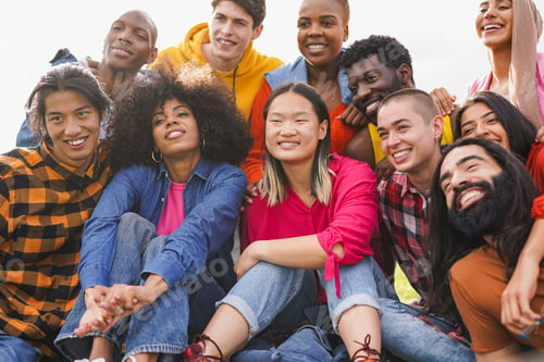 Preview: Group of multiracial young people having fun at city park