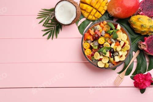Preview: Flat lay composition with delicious exotic fruit salad on pink wooden table. Space for text