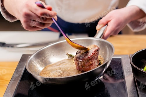 Preview: close-up of seared beef steak with rosemary topped with melted butter in frying pan
