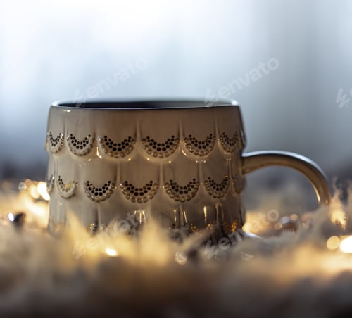 Preview: Beautiful cup on a blurred background in the dark with garlands.