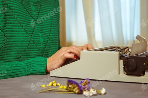 Preview: Girls hands typing in vintage typewriter