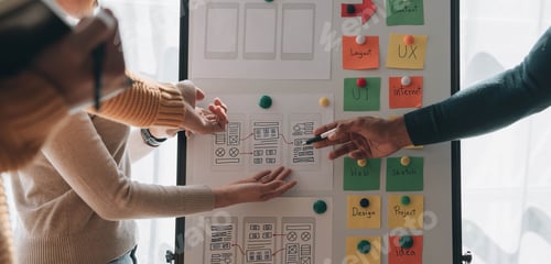 Preview: Close up ux developer and ui designer brainstorming about mobile app interface wireframe design on