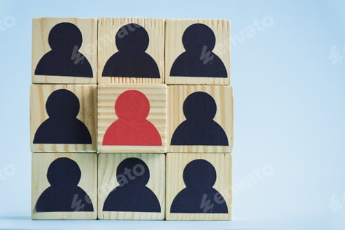 Preview: square of wooden blocks with black and red human icons on blue background, leadership concept