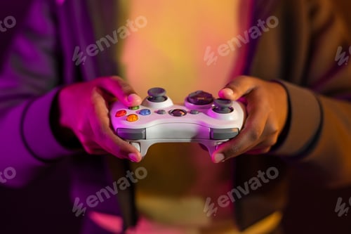 Preview: Hand playing video game using a game console entertainment technology