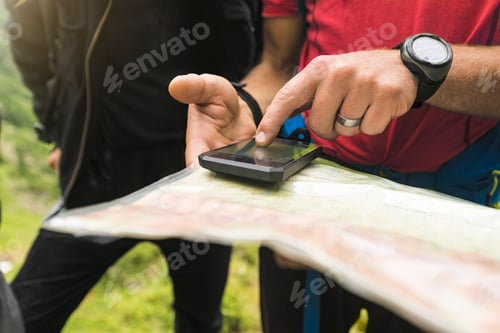 Preview: Two hikers searching for the right path with map and GPS, Carpathian Mountains, Romania