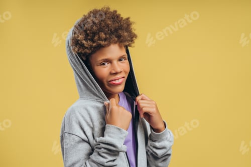 Preview: Handsome, attractive, smiling African American boy wearing stylish hoodie, looking at camera
