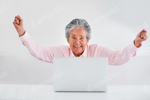Preview: Elder Woman Celebrating Her Online Success With Arms Up