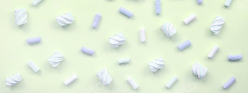 Preview: Colorful marshmallow laid out on lime paper background. pastel creative texture