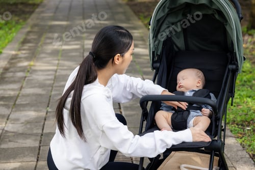 Preview: Woman take care of the baby with baby stroller at outdoor