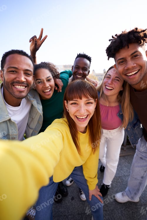 Preview: Multiethnic group of friends taking a selfie outdoors, having fun in sunny day.