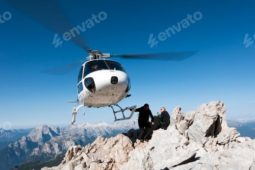 Preview: Helicopter dropping BASE jumpers on mountain, Dolomites, Italy