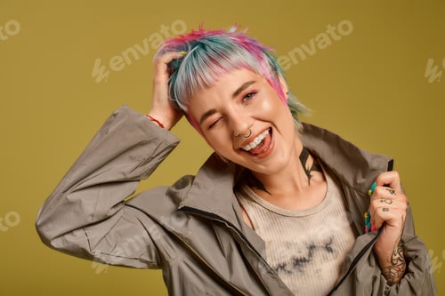 Preview: Young woman with colorful short hair enjoys a joyful moment in studio setting