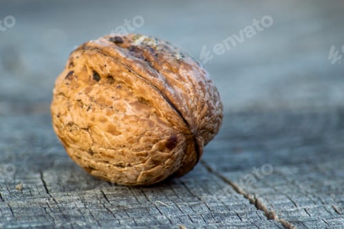 Preview: Walnut Fruit on wooden surface. Blured image. View from the front, a small depth of field.