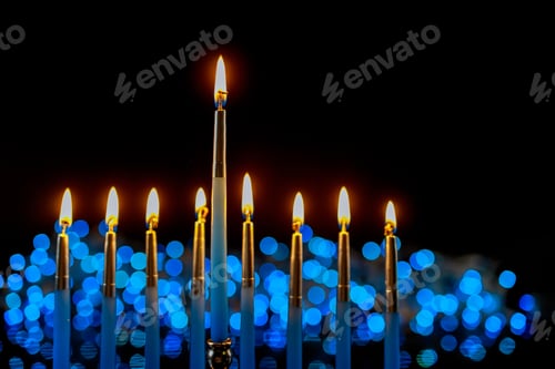 Preview: Hanukkah background with menorah and burning candles on sparkle background with defocused lights.