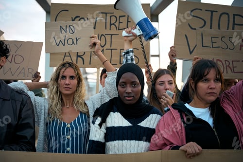Preview: Serious Muslim woman in the middle of a demonstration by a group of activists people