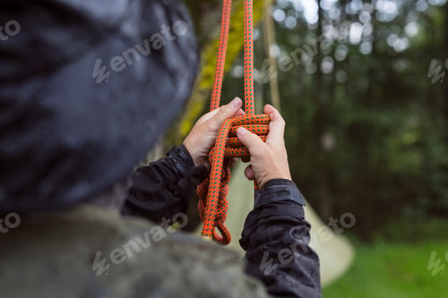 Preview: Close-up of man tying climbing rope