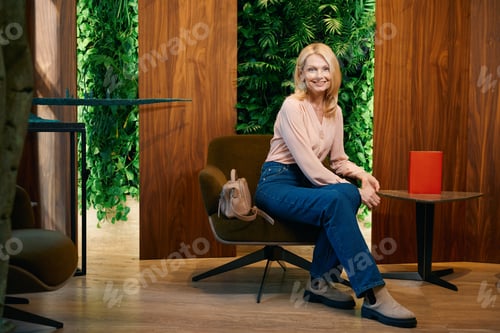Preview: Attractive lady sitting in armchair of cosmetology center