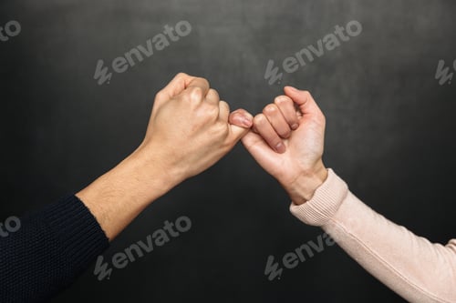 Preview: Cropped image of Asian couple holding pinkies to each other