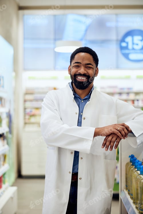 Preview: Smiling Pharmacist Standing in a Pharmacy Wearing a White Lab Coat