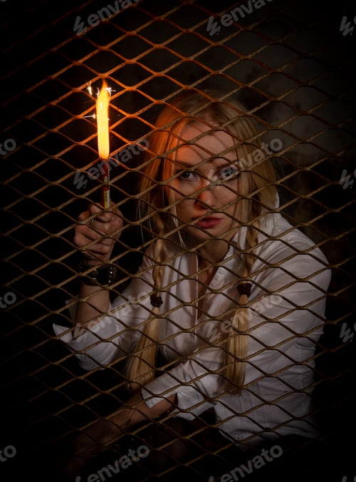 Preview: Portrait of caucasian woman behind metal frame holding a fire stick. Home isolation