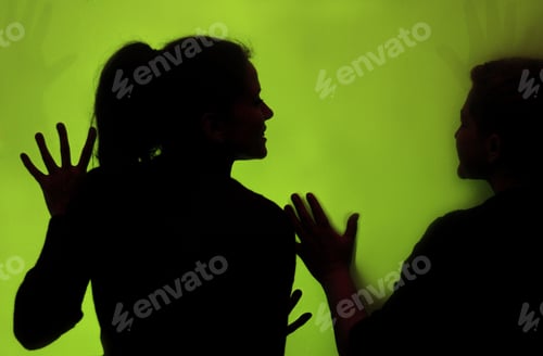 Preview: Silhouette of a woman on the green wall background