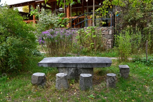 Preview: Rustic Stone Table Surrounded by Greenery at a Peaceful Outdoor Location in Autumn
