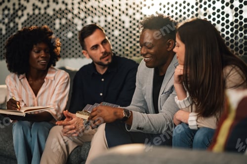 Preview: Diverse smiling ecologist presenting innovative solar panels to his team