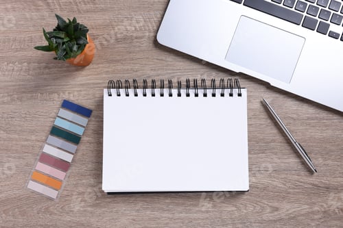 Preview: Open blank notebook, houseplant, laptop and stationery on wooden table, flat lay