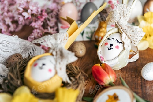 Preview: Close-up of Easter holiday decorations, food, eggs on wooden table. Easter eggs, nest, flowers.