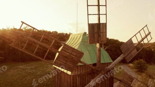 Preview: Close-up wooden mill blades in the rural area in the sunset from drone.