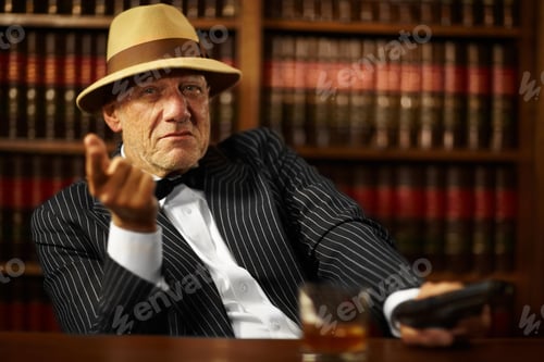 Preview: Aged mob boss wearing a hat and looking serious while pointing