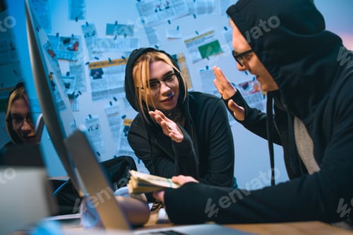 Preview: happy couple of hackers with stack of cash giving high five