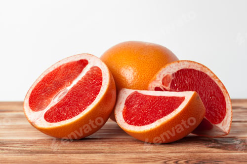 Preview: Grapefruit with slices on a wooden table