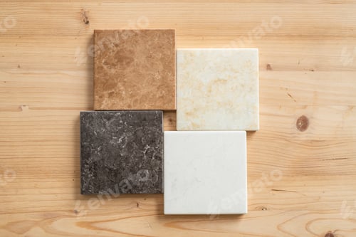 Preview: Top-down view of four marble tiles of white, black, light brown and beige colors