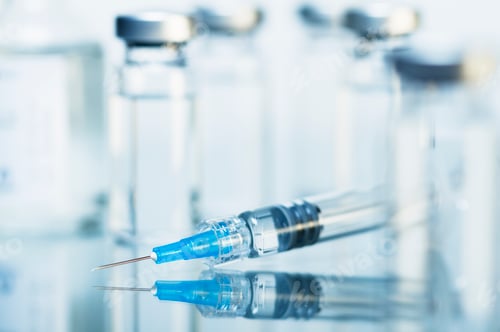 Preview: Syringe. Disposable plastic medical syringe surrounded by sealed medication vials
