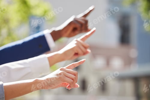 Preview: Shot of a group of unrecognizable businesspeople pointing in the same direction together outside