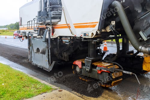 Preview: The special car with a hydrohammer removes an old paving from asphalt in the road in a construction