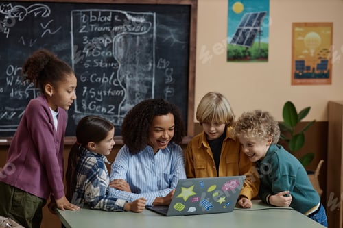 Preview: Black Woman Teacher Using Laptop with Happy School Children Watching