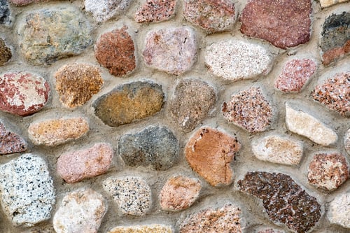 Preview: Flat detail view of a wall made from different stones. Abstract stone background