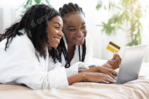 Preview: Two african american women shopping online at home