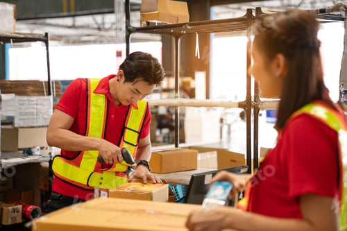 Preview: Warehouse worker team working in a large warehouse.
