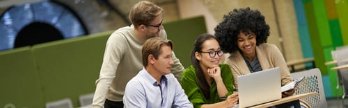 Preview: Team building. Successful multiracial business people sitting at desk in the modern coworking space