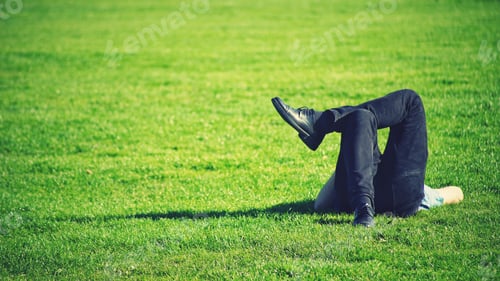 Preview: Adult Relaxing on Green Grass in Sunshine