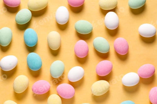 Preview: Pile of sweets on yellow background, top view